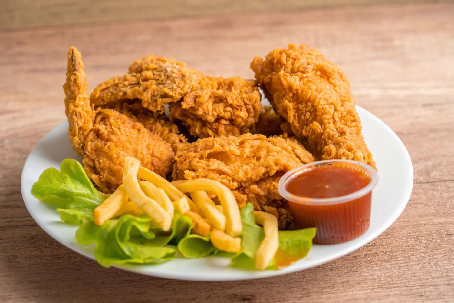 Crispy fried chicken with fries and sweet chili sauce at J Burger n Wings, a Fast - Food Restaurant in Muskegon